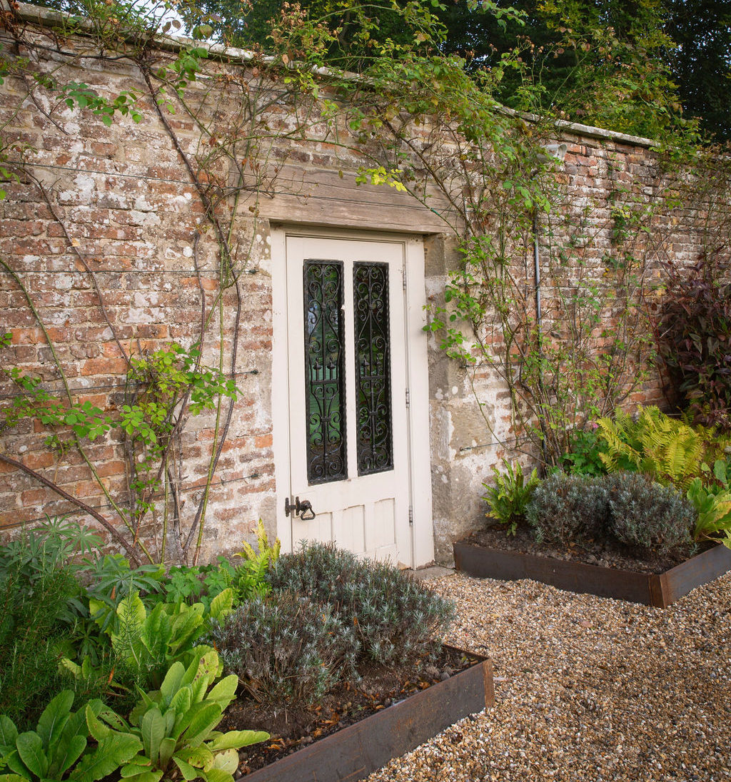 Walled garden gate, and shrubbery.