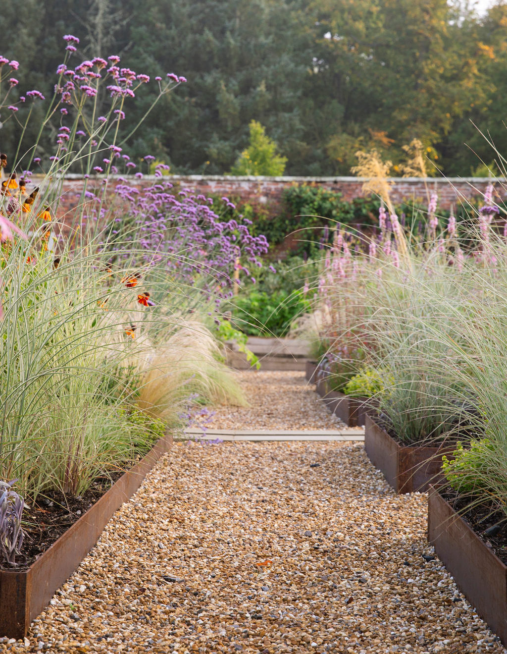 Walled garden with raised planters and shrubbery.